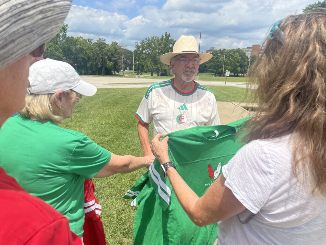 Community invited to celebration, group drone photo at Algerian flag earthwork on KU campus